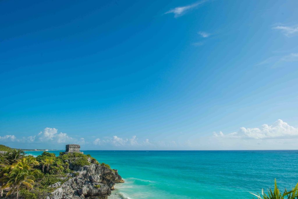 The Tulum Archaeological Site on a cliff above the turquoise Caribbean Sea