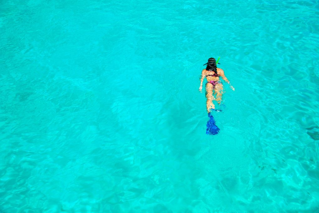 Snorkeler floating over clear turquoise water off Isla Mujeres
