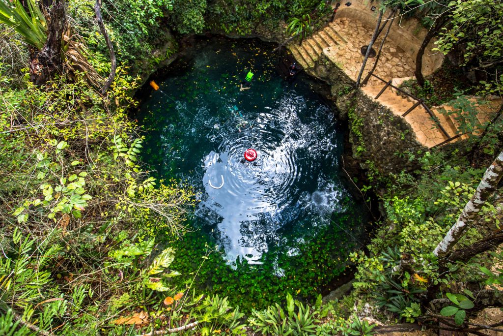 Cavern cenote with clear blue water, Puerto Morelos