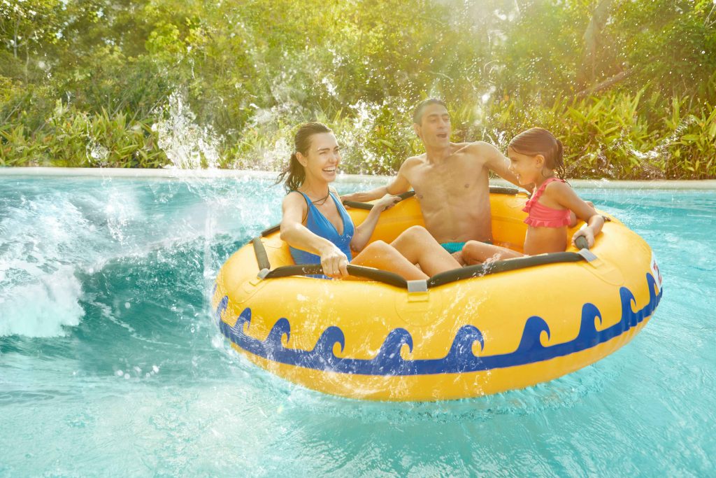 A family floating down a river on inner tubes in the Mexican Caribbean