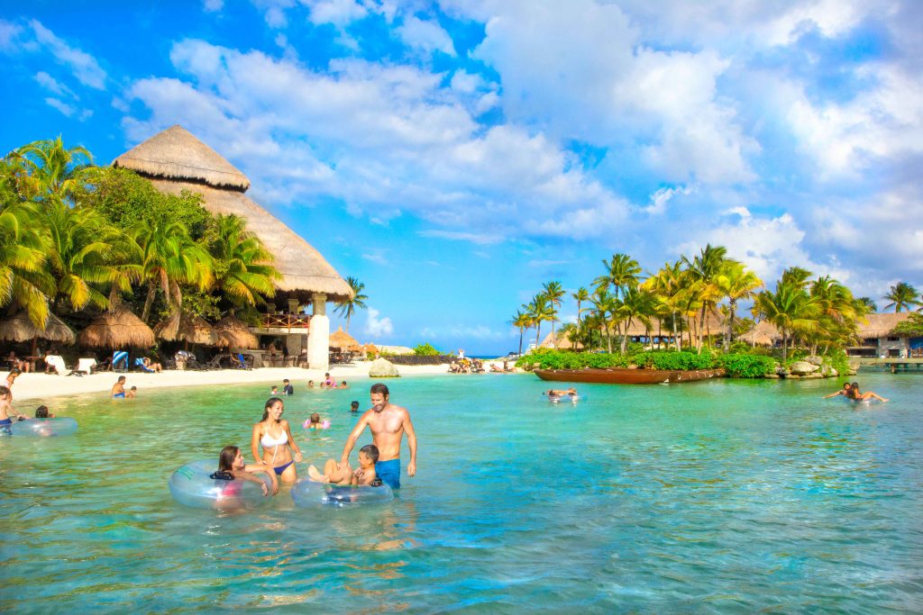 Children playing at the water's edge on a Mexican Caribbean beach